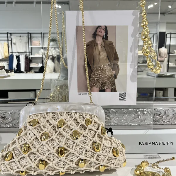 Fabiana Filippi knotted rope clutch with gold studs, styled at Lejose Fashion House