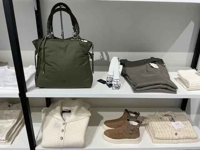 Olive tote bag, knitwear, trousers and suede boots, in-store at Lejose Fashion House